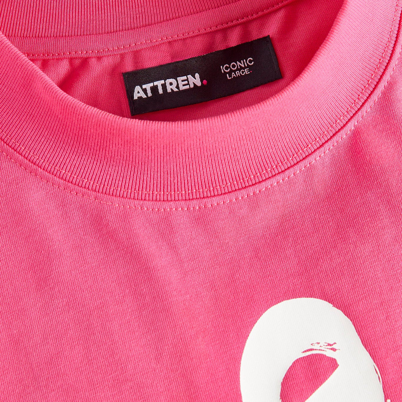 Close-up of a pink shirt with a logo and 'ATTREN' label.